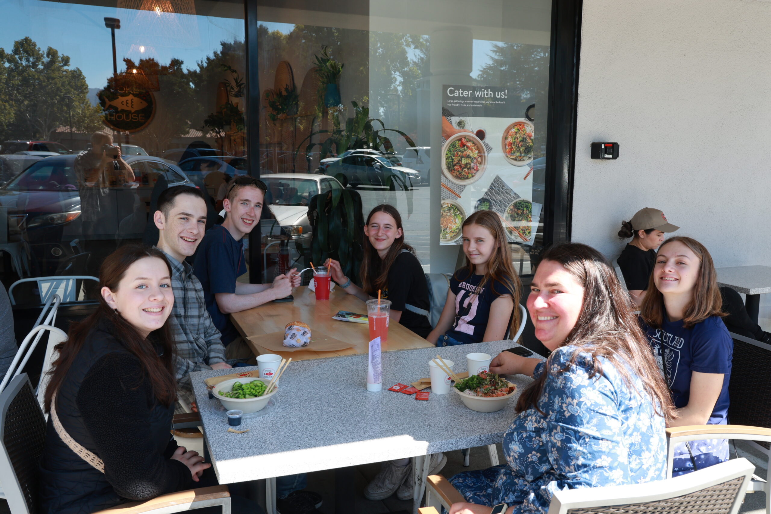 High schoolers sitting around a table for lunch