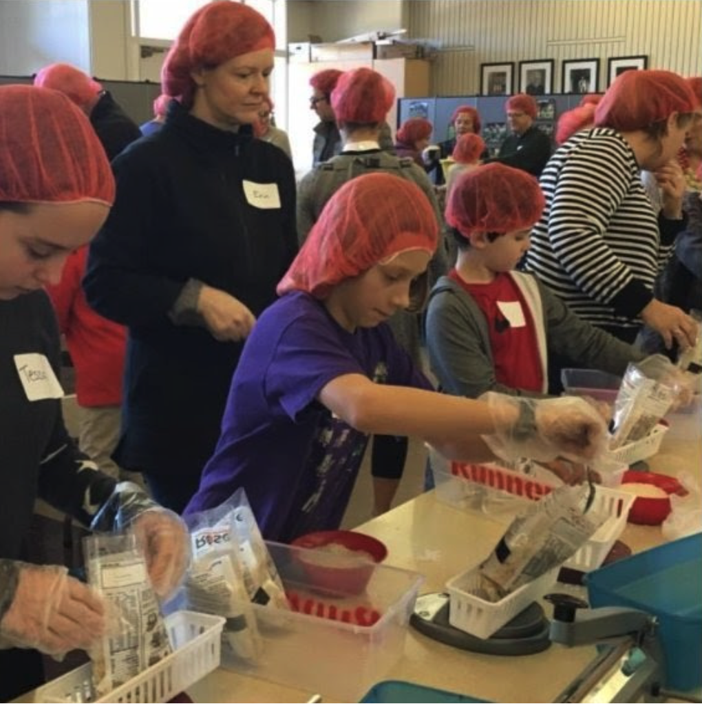 People packing meals for those in need