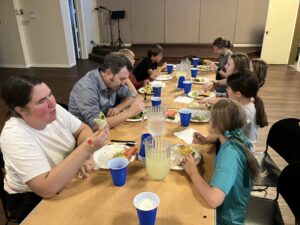 Youth gathered at a table for a meal.