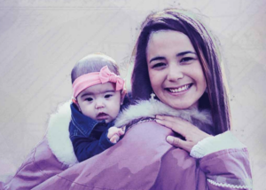 An Inuit woman with a baby on her back