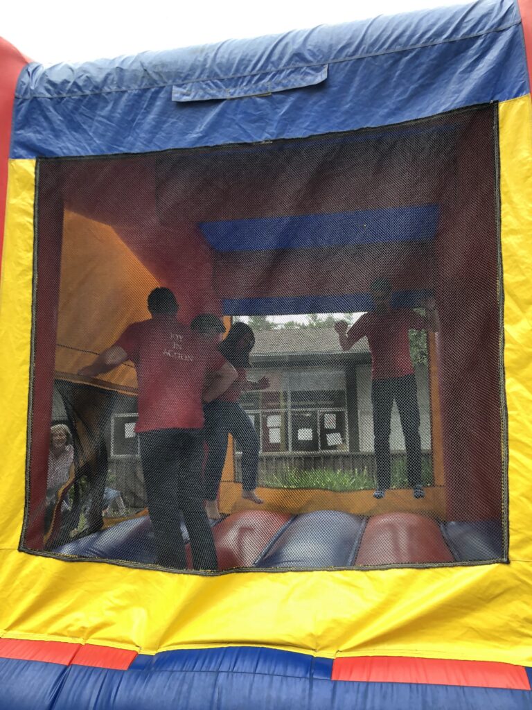 People bouncing in a bounce house