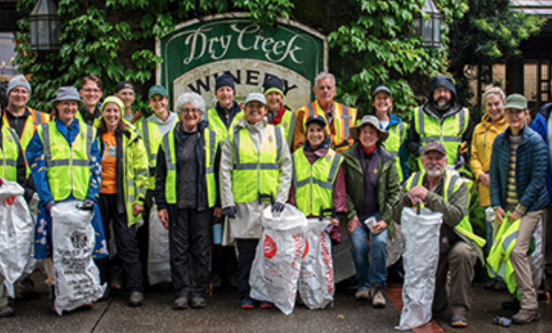 A group of people with trash bags for a clean up day