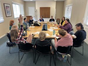 A group of youth and parents gathered around a table