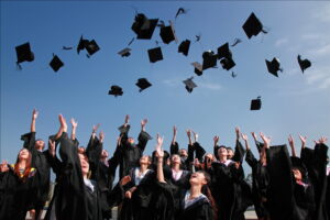 Students tossing graduation hats in the air