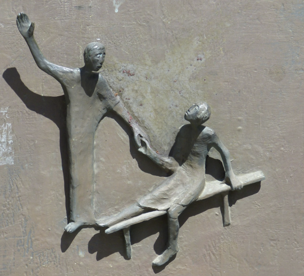 This picture is showing one person helping another person.