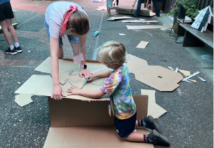 Kids playing with cardboards
