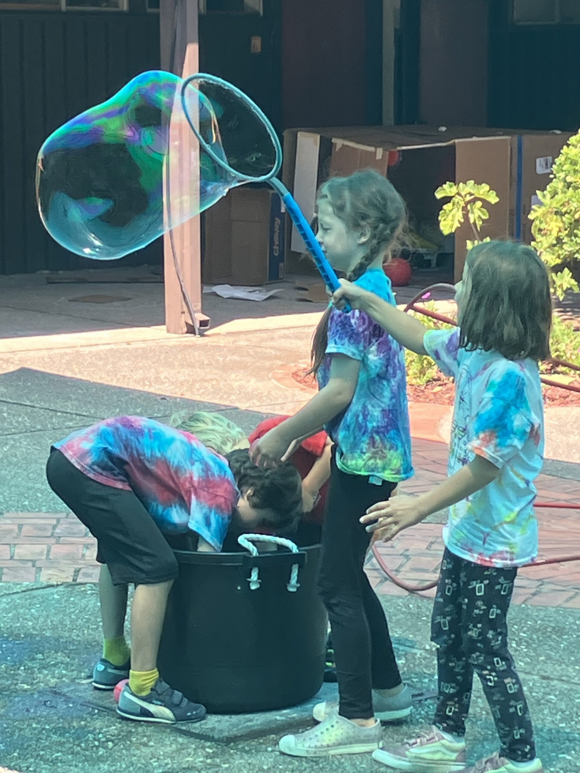 kids blowing a very big bubble
