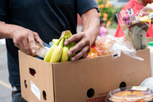 A man holding a box of bananas