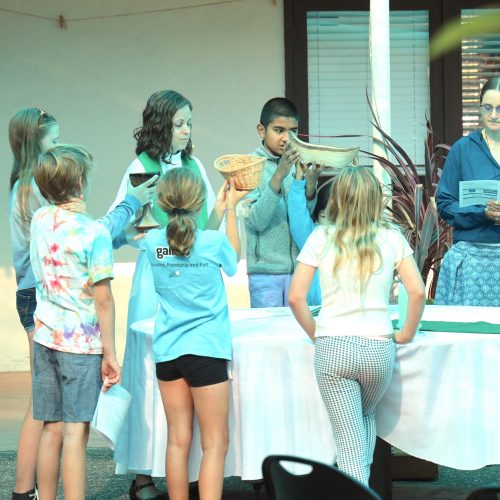 Children gathered around an altar outside