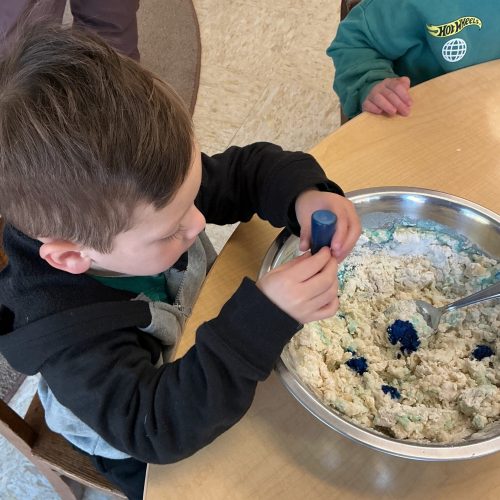 A child mixing ingredients in a bowl