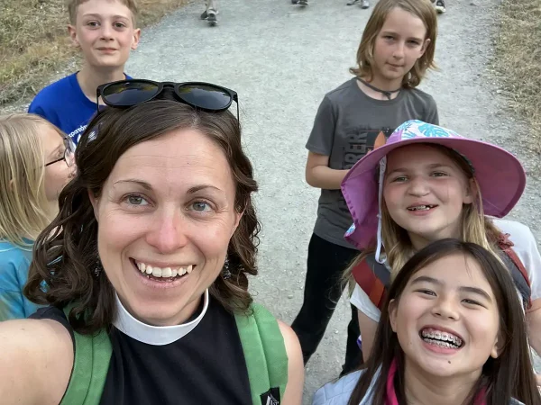Priest and kids on a hike