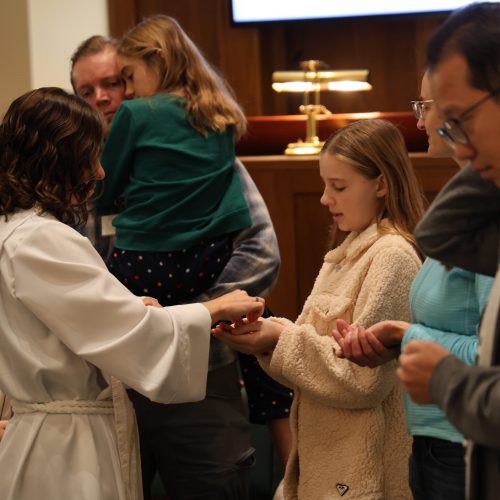 A young person receiving communion.