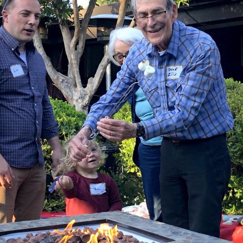 People roasting marshmallows over a fire pit