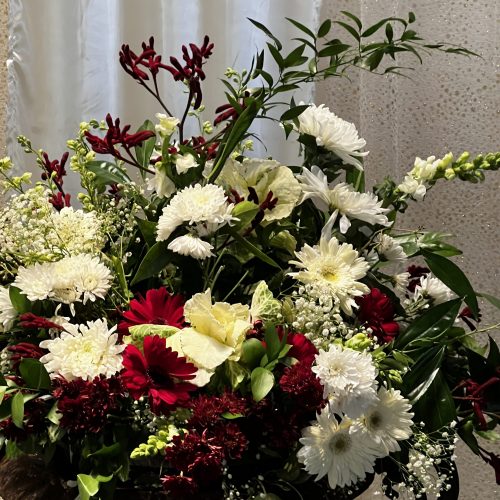 An urn of beautiful flowers prepares the space for worship