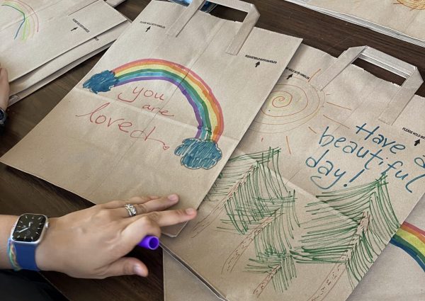 Colored paper bags saying "you are loved."