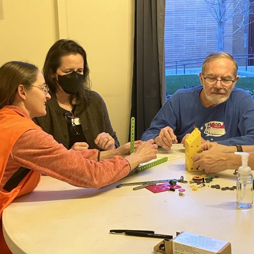 team of adults building a project together